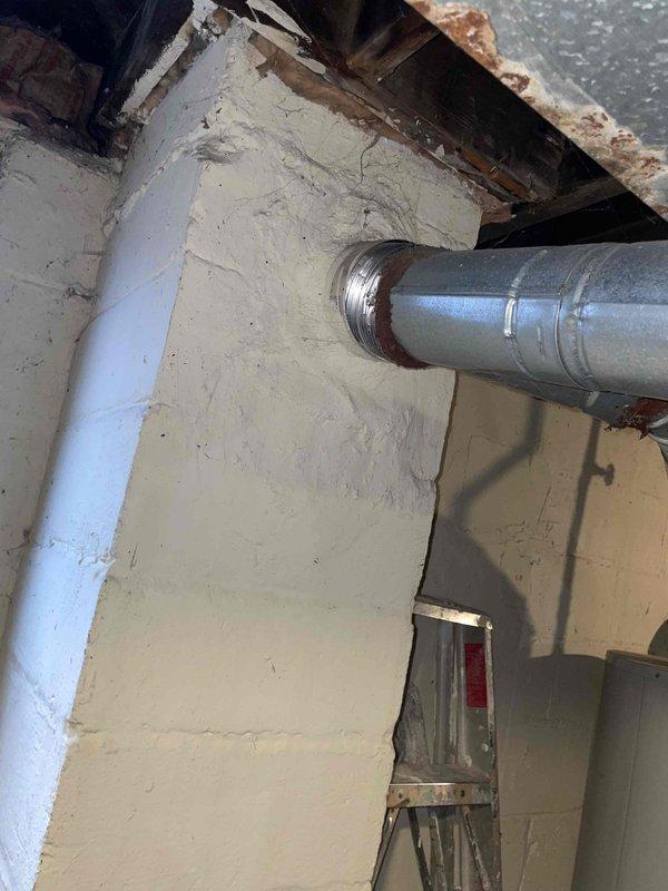 Conducted site assessment for replacement of 20-year-old basement furnace and installation of new central air conditioning system in single-family residence currently without AC. Evaluated existing ductwork, noting galvanized metal ducts with visible connecting joints and some rust at wall penetrations. Inspection revealed exposed structural elements requiring consideration during installation planning.