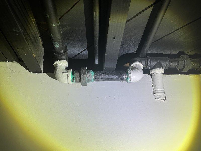 Responded to gas leak report and completed diagnostic inspection of utility area plumbing system. Located and repaired gas line connection failure at the ceiling junction point by replacing deteriorated seals and applying appropriate thread sealant to metal fitting connections. Performed pressure testing after repair to verify system integrity and ensure complete elimination of gas leakage.