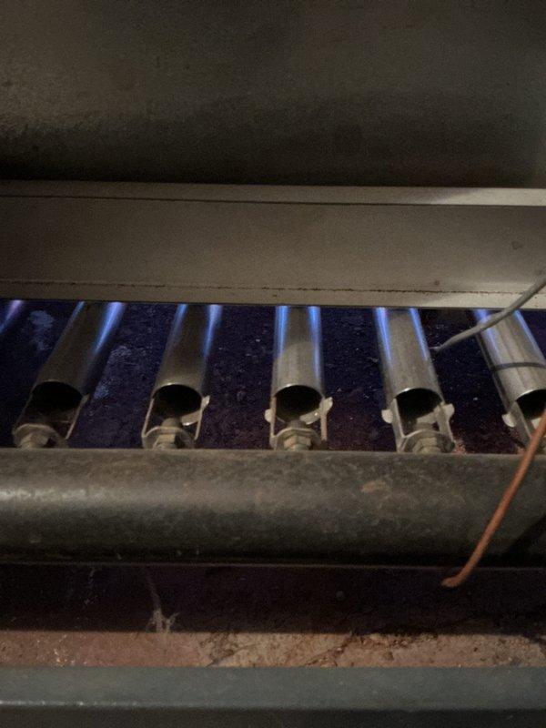 Performed Gold Furnace Inspection on a 20-year-old furnace and boiler system located in the basement. Verified proper operation of the burner assembly with visual confirmation of clean blue flame combustion across all five burners. System indicator light functioning normally, with no immediate operational concerns identified.