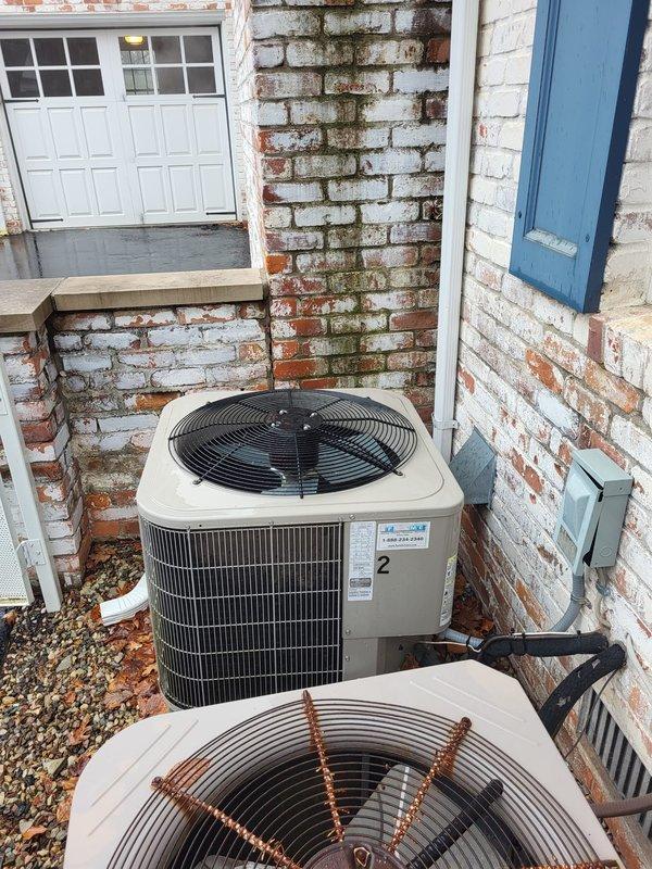 Conducted diagnostic assessment on 10+ year old furnace not heating properly, located upstairs. Inspection of existing outdoor HVAC system revealed two aging condensing units installed against brick exterior wall showing significant weathering. Recommended complete system replacement due to heat exchanger failure and overall equipment age.
