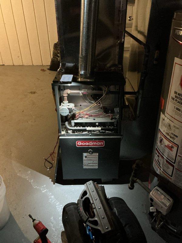 Responded to no-heat call for Goodman furnace under 10 years old located in basement. Diagnostic testing with Fieldpiece SC440 revealed faulty control board causing system failure to initiate. Replaced control board, verified proper amperage readings (0.38A), and confirmed complete system operation through multiple heating cycles.