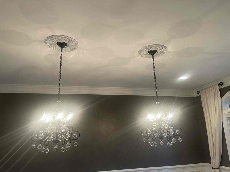 Performed consultation for electrical projects including installation of new light fixture with required electrical box and relocation of hallway outlet. Inspected existing wiring, switch placement, and ceiling fixtures to assess project scope in 10-year-old residence. Documented current lighting configuration featuring dual crystal chandeliers with decorative ceiling medallions to ensure proper replacement specifications.