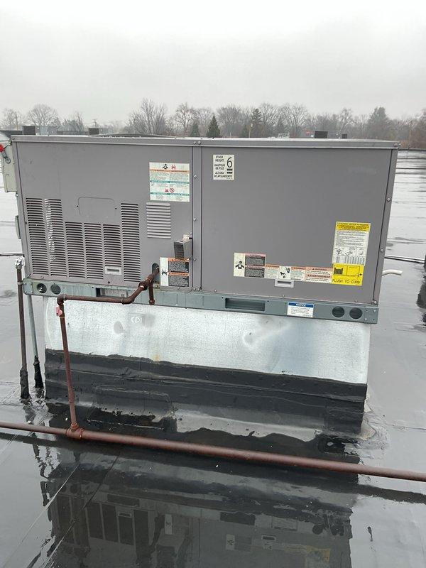 Performed city certification inspection on rooftop package unit. Observed significant rust and corrosion on internal components, particularly on metal panels and heat exchanger surfaces. Unit is installed on proper curb but standing water was noted on roof around equipment, which may be contributing to accelerated deterioration.