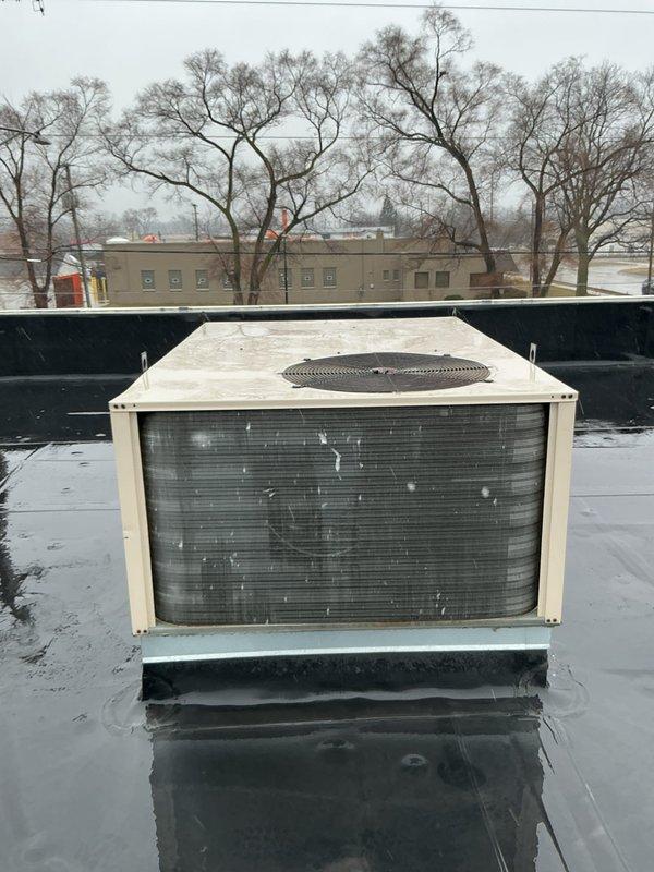 Conducted site assessment for replacement of a 20+ year old commercial rooftop unit (RTU) that is barely operational. Visual inspection revealed significant water damage to interior walls with extensive paint deterioration and cracking. Exterior examination showed weathered condenser unit with visible staining and standing water around base on flat roof. Documented conditions with photographs and prepared replacement quote as requested.