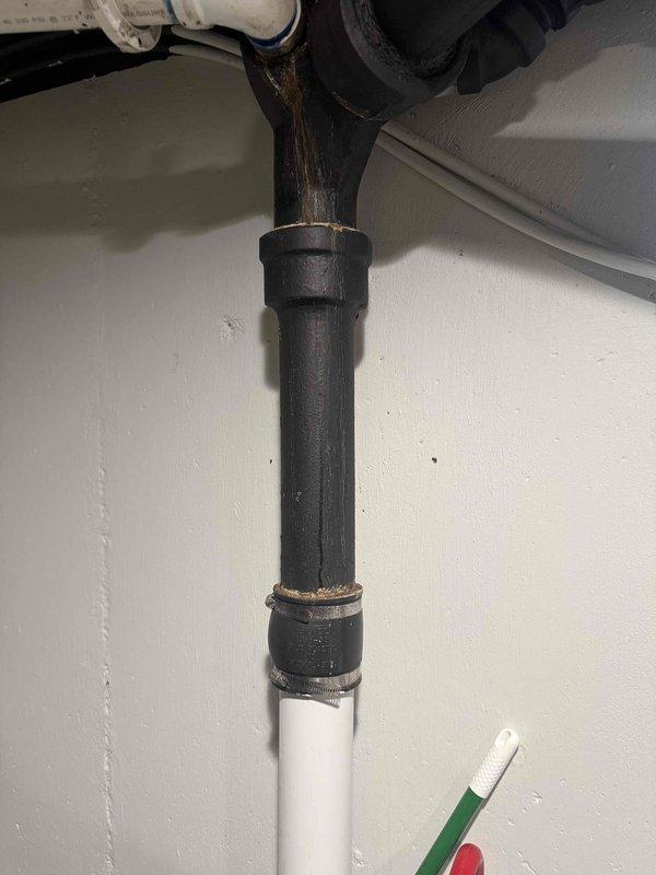 Responded to a water leak in basement where a black cast iron pipe from kitchen was found leaking at the connection joint to PVC pipe. Inspected the metal fitting showing signs of corrosion and discoloration. Also performed scheduled furnace tune-up as requested by customer.