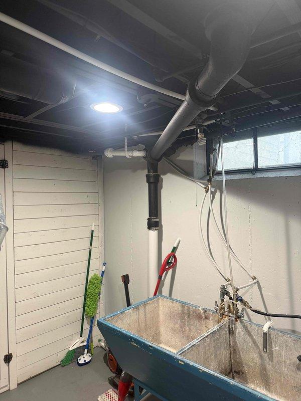 Responded to a water leak in basement where a black cast iron pipe from kitchen was found leaking at the connection joint to PVC pipe. Inspected the metal fitting showing signs of corrosion and discoloration. Also performed scheduled furnace tune-up as requested by customer.