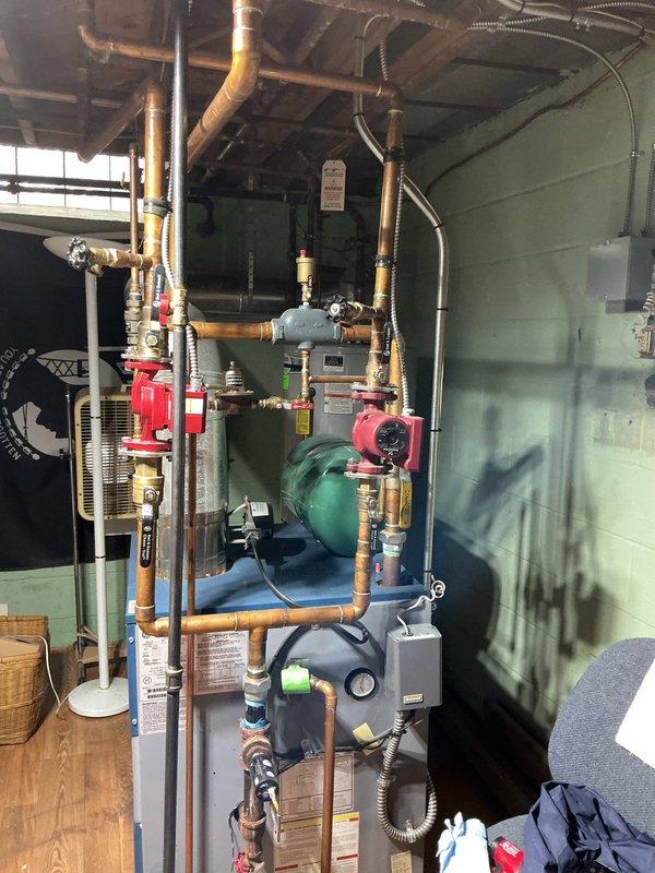 Responded to customer complaint of loud gushing water noises from 10-year-old boiler system. Performed comprehensive inspection of the hydronic heating system, including examination of circulation pumps, expansion tank, and all associated valves and gauges. Purged air from the system by bleeding radiators and draining excess water, which resolved the noise issue and restored normal operation.