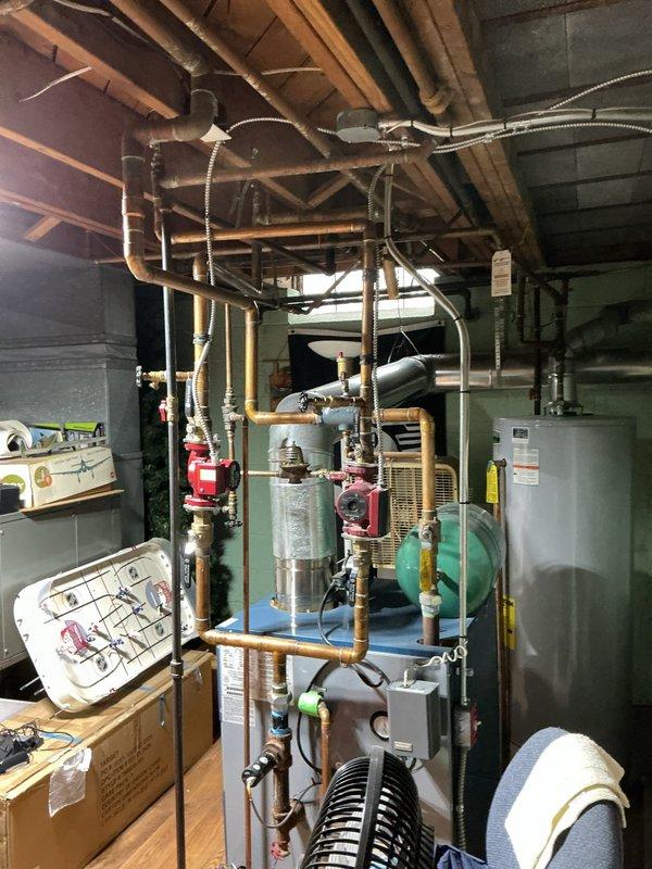 Responded to customer complaint of loud gushing water noises from 10-year-old boiler system. Performed comprehensive inspection of the hydronic heating system, including examination of circulation pumps, expansion tank, and all associated valves and gauges. Purged air from the system by bleeding radiators and draining excess water, which resolved the noise issue and restored normal operation.