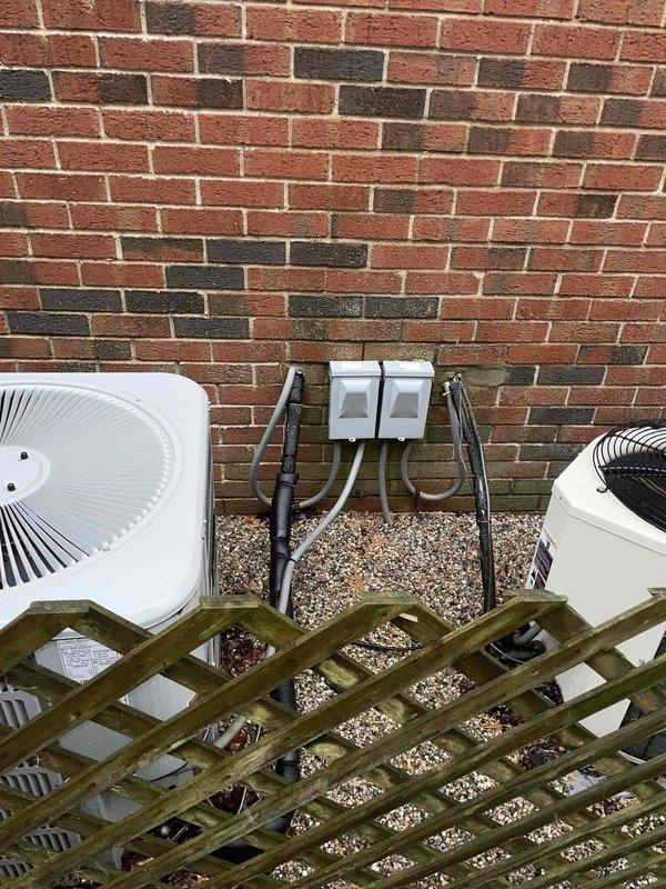 Conducted estimate for replacement of 25-year-old AC and furnace system in gated community residence. Current equipment is operational but at end of service life. Customer expressed preference for Lennox equipment. Visual inspection revealed outdoor units positioned against brick wall with protective lattice screening, requiring evaluation for proper clearance and airflow in new installation design.