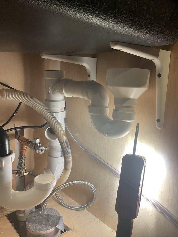Completed installation of garbage disposal unit beneath kitchen sink, including connection to existing PVC drain system with proper P-trap configuration. Verified all plumbing connections were secure with no leaks, and confirmed proper electrical connection to nearby outlet.