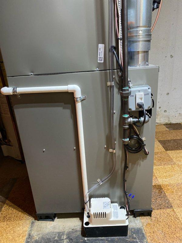 Successfully installed a complete HVAC system consisting of a 70,000 BTU furnace and 2-ton AC unit in basement location. Installation included proper ductwork connections with elbow joints, PVC venting, electrical connections, condensate pump setup, and liner installation. System was fully tested and verified to be operating according to manufacturer specifications.