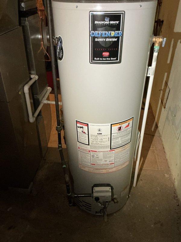 Diagnosed Bradford White water heater with pilot light issue affecting hot water supply. Inspected gas control valve and ignition assembly, discovering pilot light had extinguished. Cleaned thermocouple, relit pilot light, and verified proper operation with stable flame. Hot water now functioning at appropriate temperature.