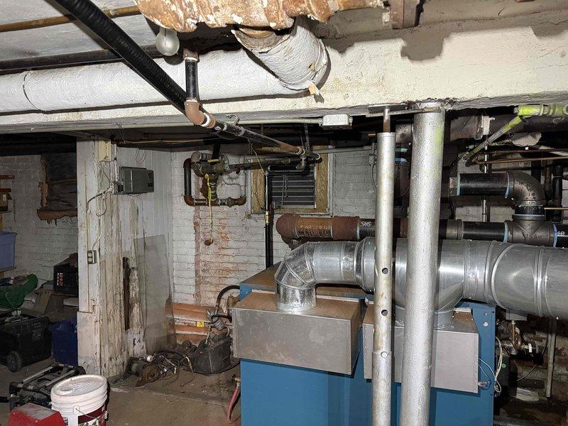 Responded to no-heat call for a 2-year-old boiler system. Inspected the blue heating unit in basement utility area, examining connections to copper piping and ductwork. Resolved the heating issue and verified proper system operation before departure.