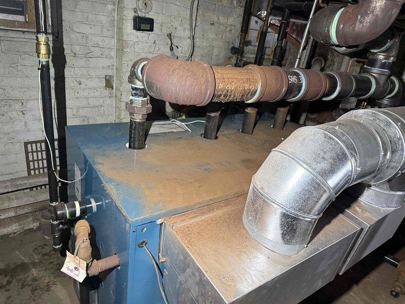 Responded to no-heat call for a 2-year-old boiler system. Inspected the blue heating unit in basement utility area, examining connections to copper piping and ductwork. Resolved the heating issue and verified proper system operation before departure.