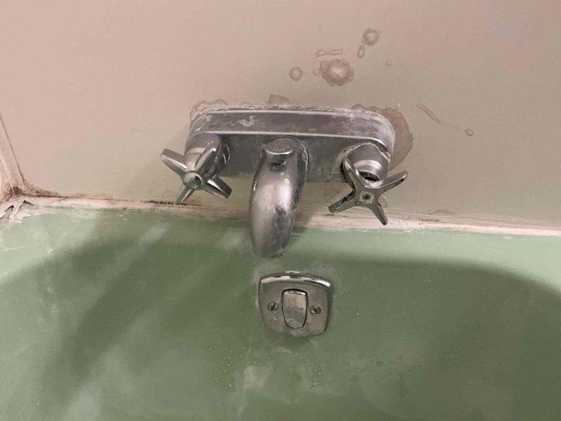 Performed leak repair service on second-floor bathtub faucet. Diagnosed and addressed deteriorated seals and worn valve components causing water seepage. Completed necessary repairs to eliminate the leak and prevent further water damage to surrounding wall structure.