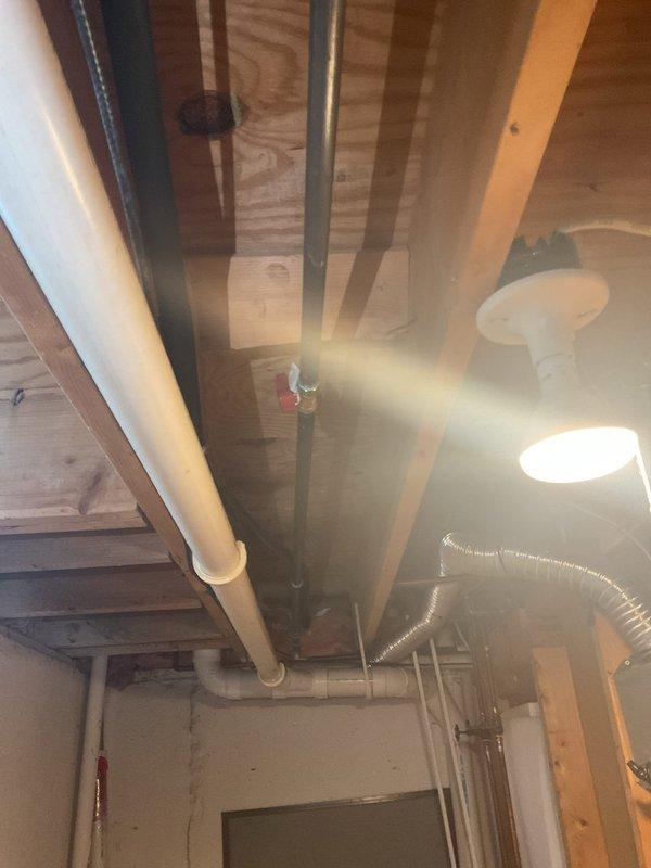 Conducted comprehensive inspection of exposed basement plumbing system, documenting condition of PVC and copper piping installations. Examined connection points, valves, and joint integrity throughout the utility area, with particular attention to the ceiling corner installation where insulation meets plumbing infrastructure. No immediate issues identified in the wooden structural components supporting the plumbing network.