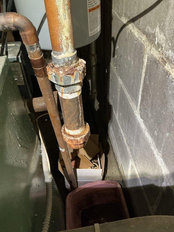 Replaced faulty 30psi pressure relief valve and installed new pressure reducing valve eliminator on severely corroded copper pipe system connected to boiler unit, addressing active water leak and preventing potential system failure.