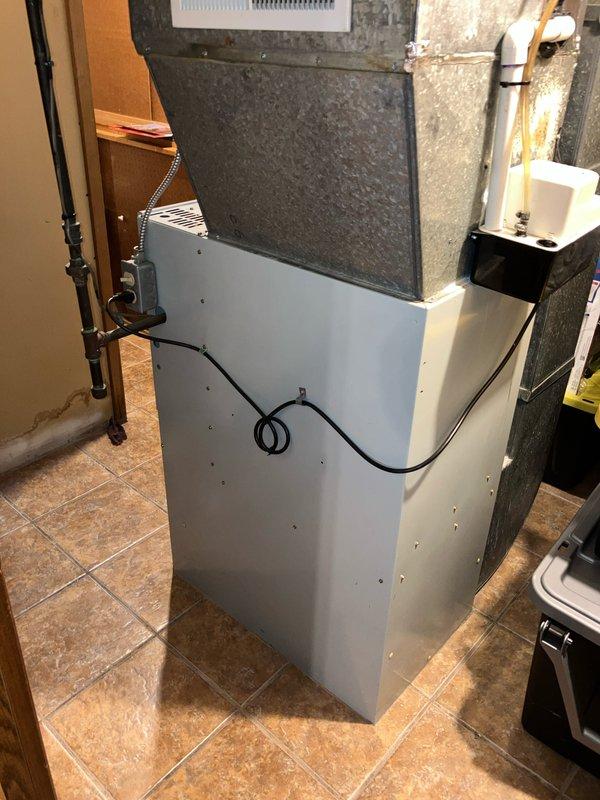 Provided estimate for replacement of a 30-year-old natural gas furnace located in basement utility closet with louvered bi-fold doors. Current unit is operational but has exceeded typical service life. Inspection revealed standard residential heating system with connected ductwork, condensate drain line, and associated mechanical components that would need to be integrated with any replacement system.