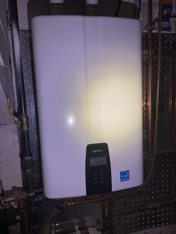 Performed Gold Boiler Inspection on 4-year-old Navien wall-mounted hot water boiler system located in basement. Unit was operational with proper connections to copper piping; all components were visually inspected and found to be functioning within normal parameters. ENERGY STAR certified system showed no signs of issues requiring immediate service.