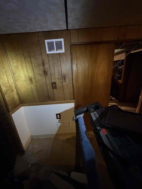 Addressed City of Troy electrical and mechanical violations by adjusting the switch position between ductwork for proper accessibility and installed approved combustion air supply to the mechanical room. Verified compliance using laser level measurements and documented the wooden panel wall conditions with ventilation components before and after corrections.