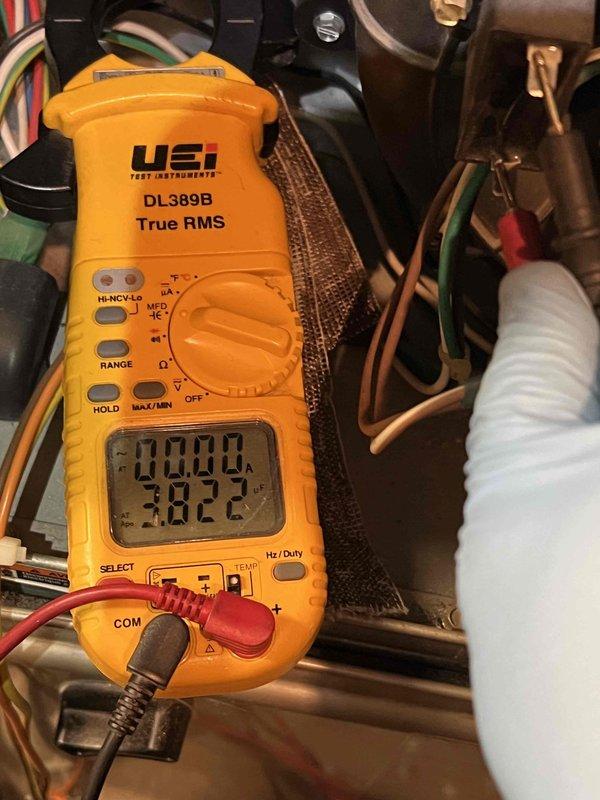 Performed comprehensive tune-up on 12-year-old HVAC system located in basement. Noted previous water damage with visible flood mark on unit exterior. Conducted electrical diagnostics using multimeter, verifying proper voltage readings and electrical connections. System is operational but shows signs of age and previous water exposure.