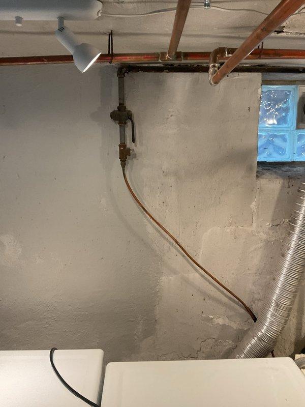 Successfully installed new gas line for dryer in basement of 3-year-old home. Work involved routing black iron pipe vertically along basement wall with appropriate shutoff valve installation. Existing utility area was properly accessed with minimal disruption to the finished space.