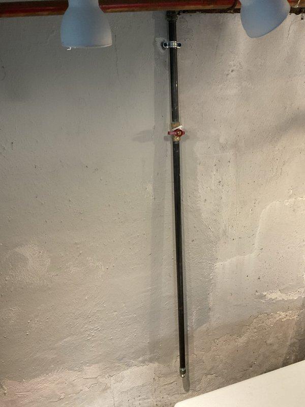 Successfully installed new gas line for dryer in basement of 3-year-old home. Work involved routing black iron pipe vertically along basement wall with appropriate shutoff valve installation. Existing utility area was properly accessed with minimal disruption to the finished space.