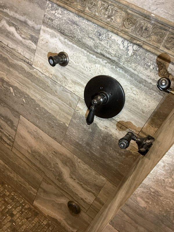 Responded to service call for no hot water from electric water heater and a faulty shower valve that would not turn off. Diagnosed and repaired the electric water heater to restore hot water functionality, and replaced the defective shower valve in the master bathroom to correct the continuous water flow issue.