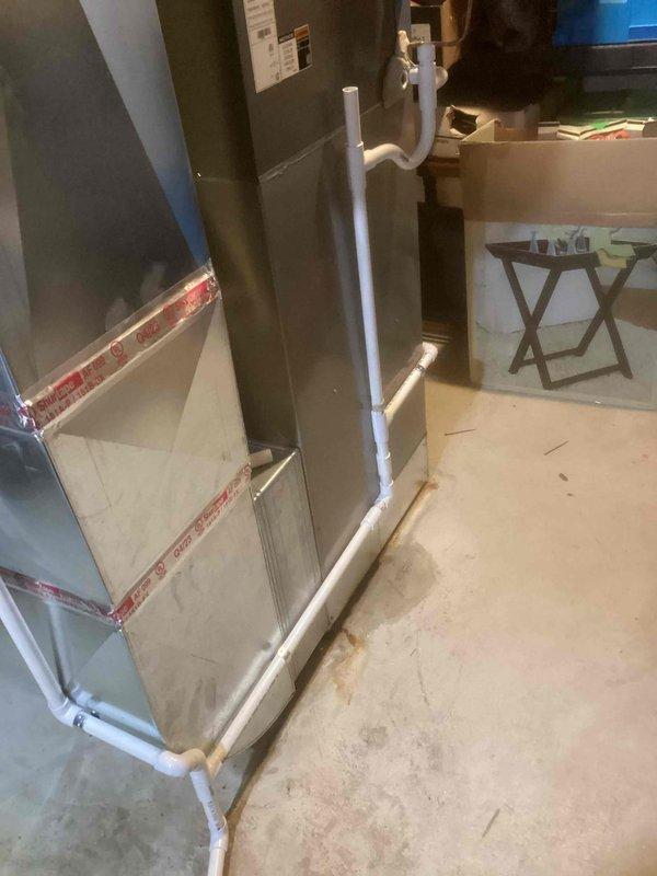 Diagnosed and repaired leak from 6-year-old furnace located in basement. Identified condensate drain system as source of water leakage, cleaned clogged drain lines and installed proper P-trap configuration on PVC condensate piping to prevent future drainage issues. System now functioning properly with no signs of leakage.