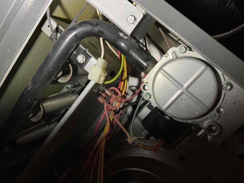 Performed comprehensive tune-up service on an upstairs furnace less than 10 years old. Inspected electrical connections, including terminal block wiring and motor assembly, confirming all components were properly secured and functioning. Noted minor dust accumulation on internal components but system appears to be in normal working condition with no visible damage or anomalies detected.