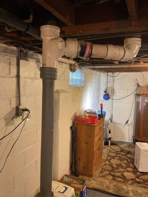 Successfully rerouted sump pump discharge line from exterior to basement laundry sink to prevent outdoor freezing and mess issues. Installed new PVC piping system along ceiling joists with proper connections and fittings to ensure effective drainage and compliance with plumbing codes.
