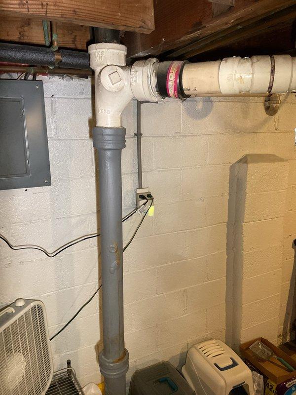 Successfully rerouted sump pump discharge line from exterior to basement laundry sink to prevent outdoor freezing and mess issues. Installed new PVC piping system along ceiling joists with proper connections and fittings to ensure effective drainage and compliance with plumbing codes.