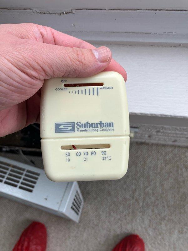 Performed diagnostic assessment on 30+ year old Suburban Manufacturing mini-split ductless heat pump located on customer's porch that was reported non-operational. Examination revealed severely outdated thermostat control system with mechanical components showing significant wear. Documented condition of internal wiring connections and temperature regulation mechanism for replacement recommendation.