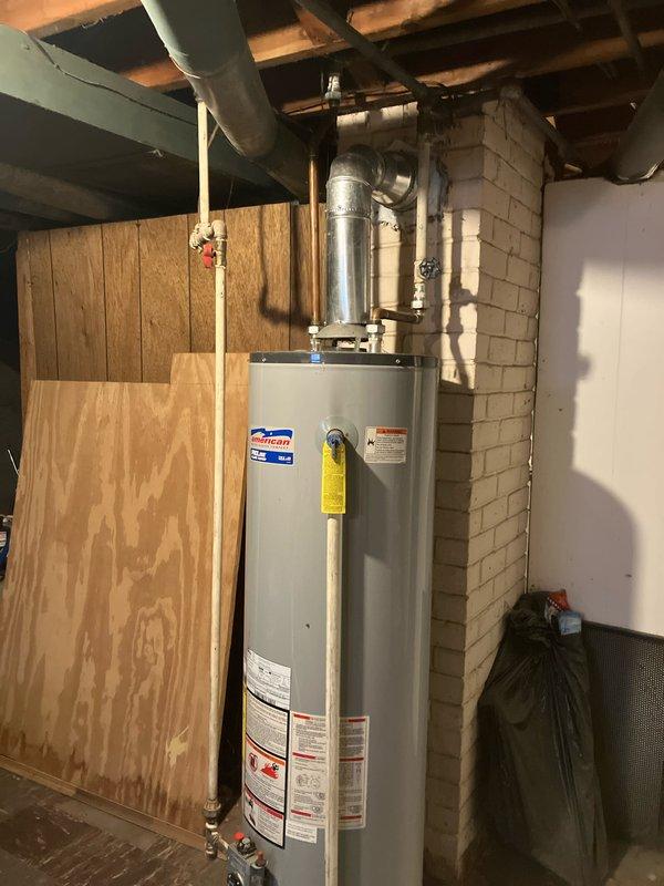 Conducted assessment for new AC installation in residence with existing 10-year-old gas furnace located in basement. Documented current Honeywell thermostat showing 65°F/64% humidity readings and inspected existing water heater setup with proper venting. Prepared comprehensive replacement estimate for AC-only installation based on site evaluation.