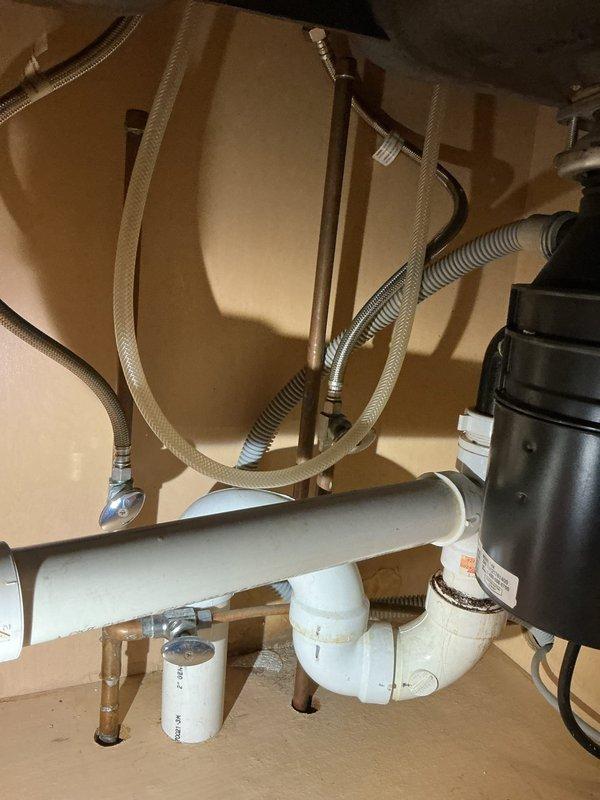 Successfully reconnected water supply lines, installed P-trap drain assembly, and connected garbage disposal unit under kitchen sink. Ensured proper installation of all flexible supply lines including dishwasher connection. All connections were tested for leaks and proper function.