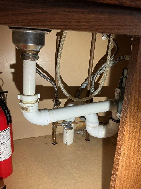 Successfully reconnected water supply lines, installed P-trap drain assembly, and connected garbage disposal unit under kitchen sink. Ensured proper installation of all flexible supply lines including dishwasher connection. All connections were tested for leaks and proper function.