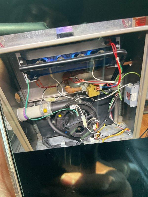 Installed additional control wire to HVAC system per approved estimate, connecting from circuit board terminal block to gas valve assembly. Verified proper connection of all existing wiring (red, blue, green, yellow, white, orange, purple) to ensure system functionality after modification.