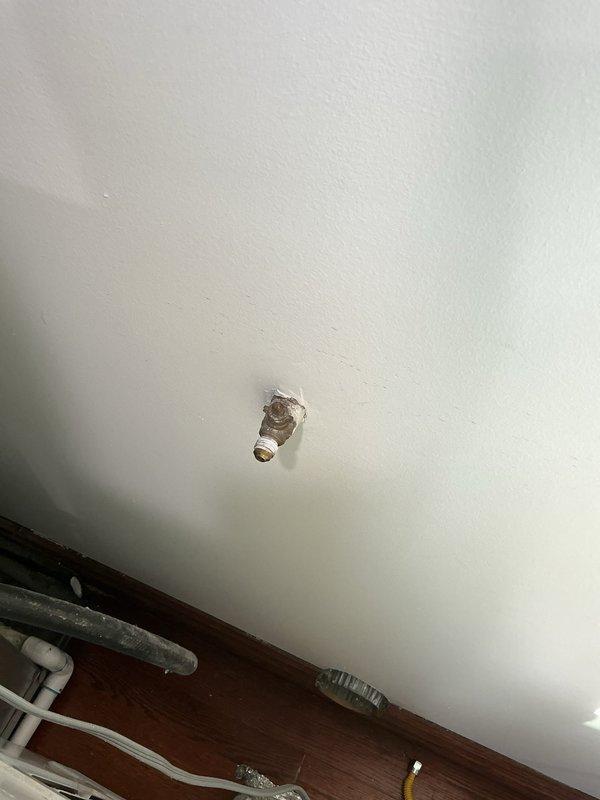 Installed a new gas line with proper shutoff valve for customer's appliance. Connected flexible stainless steel connector to existing gas pipe, ensuring secure mounting to wall and appropriate penetration through wooden floor surface. All connections were tested for leaks after installation to verify safe operation.