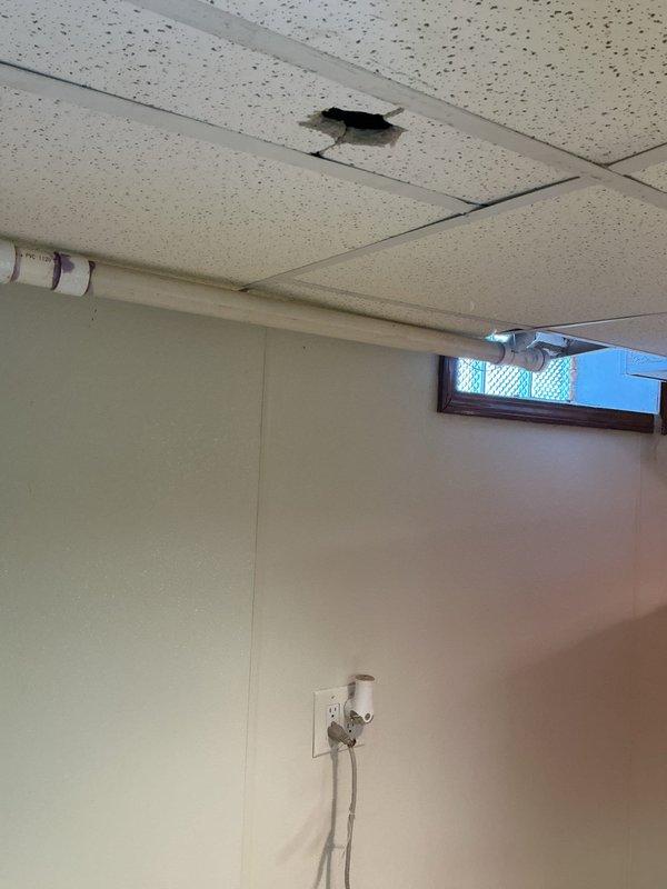 Responded to service call for waste pipe issue in 98-year-old home. Inspected plumbing infrastructure in basement where problem had been gradually developing. Identified and cleared blockage in the drainage system, verifying proper flow through the main vertical PVC pipe and its Y-junction connections to ensure full functionality of the waste pipe system.