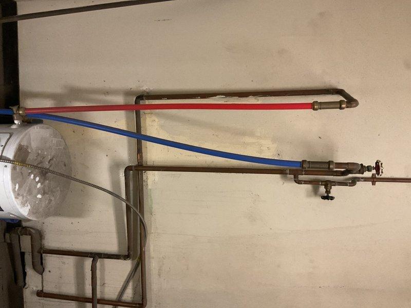 Diagnosed 10-gallon commercial water heater showing active leakage from bottom of tank with visible rust/corrosion at base. Inspection revealed tank failure requiring complete replacement; documented condition with photos showing deteriorated connections and staining on surrounding concrete floor.