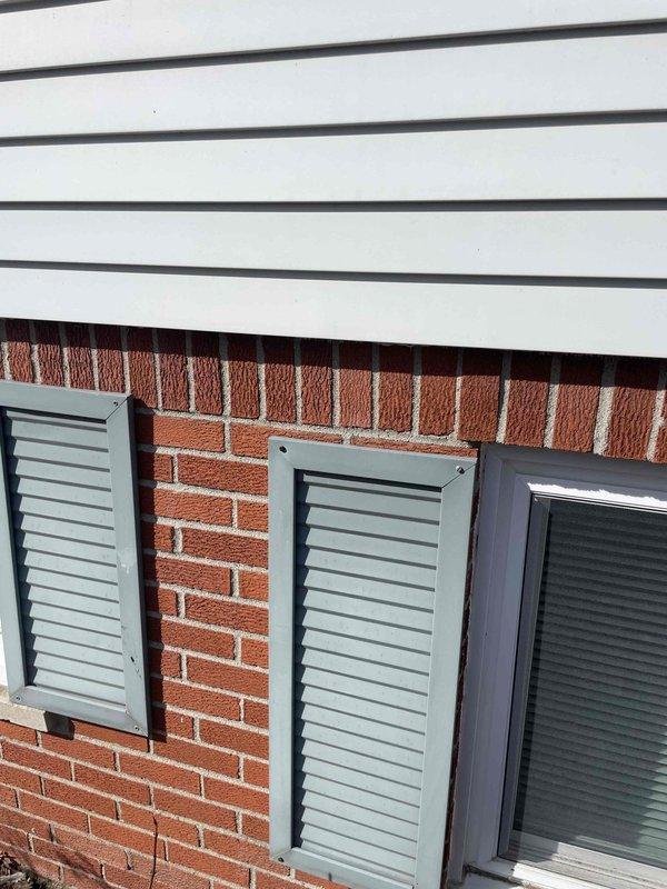 Conducted full HVAC system estimate for replacement of existing furnace and air conditioning unit. Inspected exterior ventilation including louvered vents on brick exterior and examined interior ductwork configuration in unfinished ceiling area. Evaluation included assessment of current metal ductwork condition and available space for new system installation.