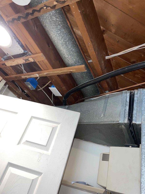 Conducted full HVAC system estimate for replacement of existing furnace and air conditioning unit. Inspected exterior ventilation including louvered vents on brick exterior and examined interior ductwork configuration in unfinished ceiling area. Evaluation included assessment of current metal ductwork condition and available space for new system installation.