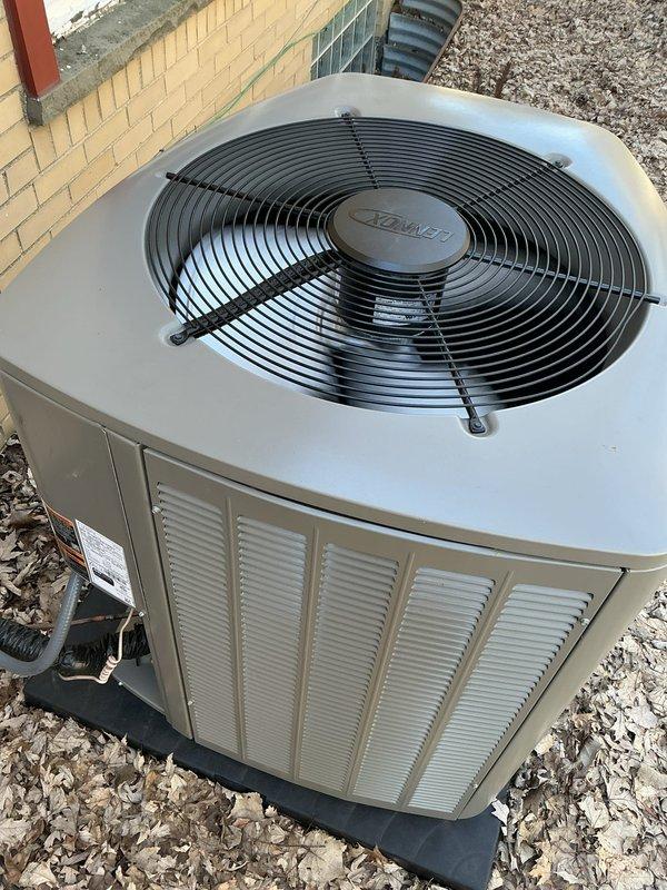 Completed startup of newly installed Lennox air conditioning system. Unit properly positioned on black pad with mulch surrounding the outdoor condenser. Verified proper fan operation and electrical connections, with all components functioning as expected.
