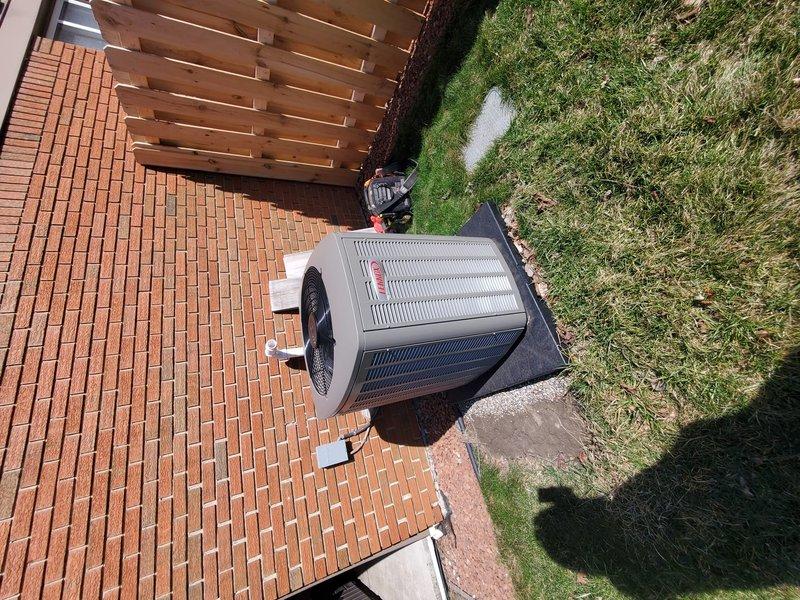 Performed AC system start-up service on residential split-system air conditioner. Verified proper installation of outdoor condensing unit on concrete pad adjacent to brick patio area. Confirmed unit operation with appropriate clearances for proper airflow and ventilation.