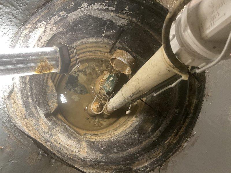 Replaced failing sump pump system in basement utility area, removing corroded metal components and installing new PVC discharge piping with proper electrical connections. System was thoroughly tested to ensure proper water evacuation and function of the new pump assembly.