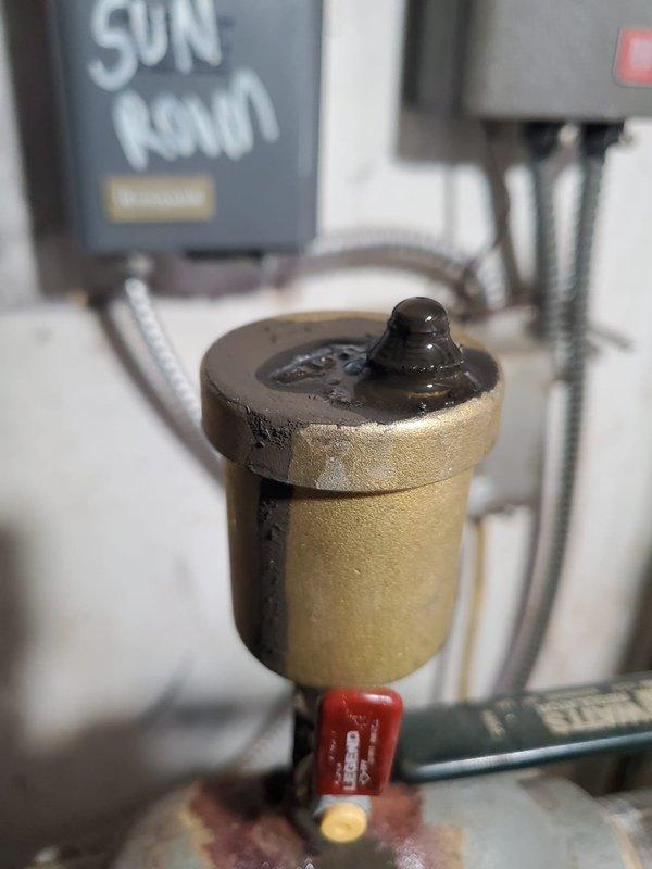 Responded to service call for loud noise from residential boiler located in garage. Upon inspection of the 10+ year old system, discovered malfunctioning air vent/pressure release valve showing signs of moisture and residue accumulation. Replaced faulty valve to eliminate noise issue and restore proper system operation.