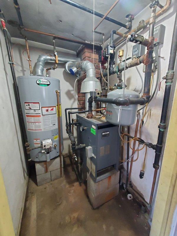 Responded to service call for loud noise from residential boiler located in garage. Upon inspection of the 10+ year old system, discovered malfunctioning air vent/pressure release valve showing signs of moisture and residue accumulation. Replaced faulty valve to eliminate noise issue and restore proper system operation.