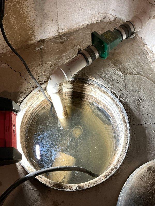 Responded to service call for non-functioning sump pump in basement of 30-year-old residence. Upon inspection, found the existing unit had failed and required replacement. Installed new sump pump, verified proper operation with the existing discharge piping and check valve, and confirmed system was properly connected to power source.