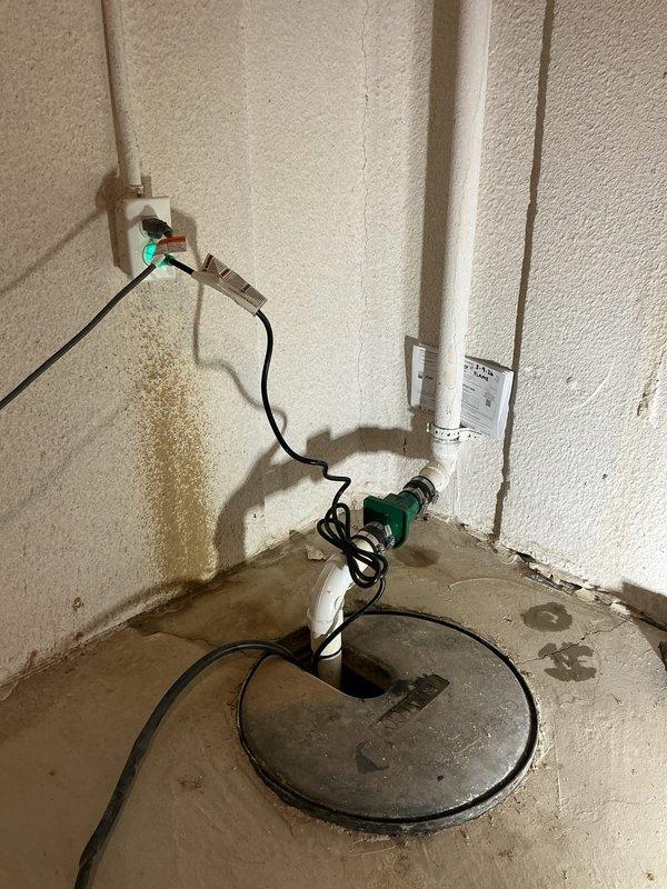 Responded to service call for non-functioning sump pump in basement of 30-year-old residence. Upon inspection, found the existing unit had failed and required replacement. Installed new sump pump, verified proper operation with the existing discharge piping and check valve, and confirmed system was properly connected to power source.