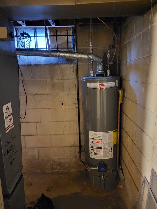 Performed evaluation of aging gas furnace in basement showing significant noise issues during operation. Unit appears functional but at end of service life, with visible wear on ductwork connections and potential efficiency concerns. Replacement quote provided for new high-efficiency system that would address noise concerns and improve overall heating performance while maintaining compatibility with existing ductwork configuration and nearby water heater installation.